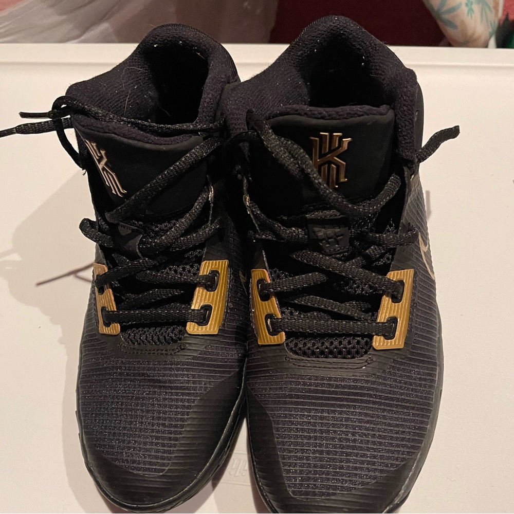 Nike Kyrie 4s.  Black and Gold ‘big boys’ size 6.5 in great condition.  No box